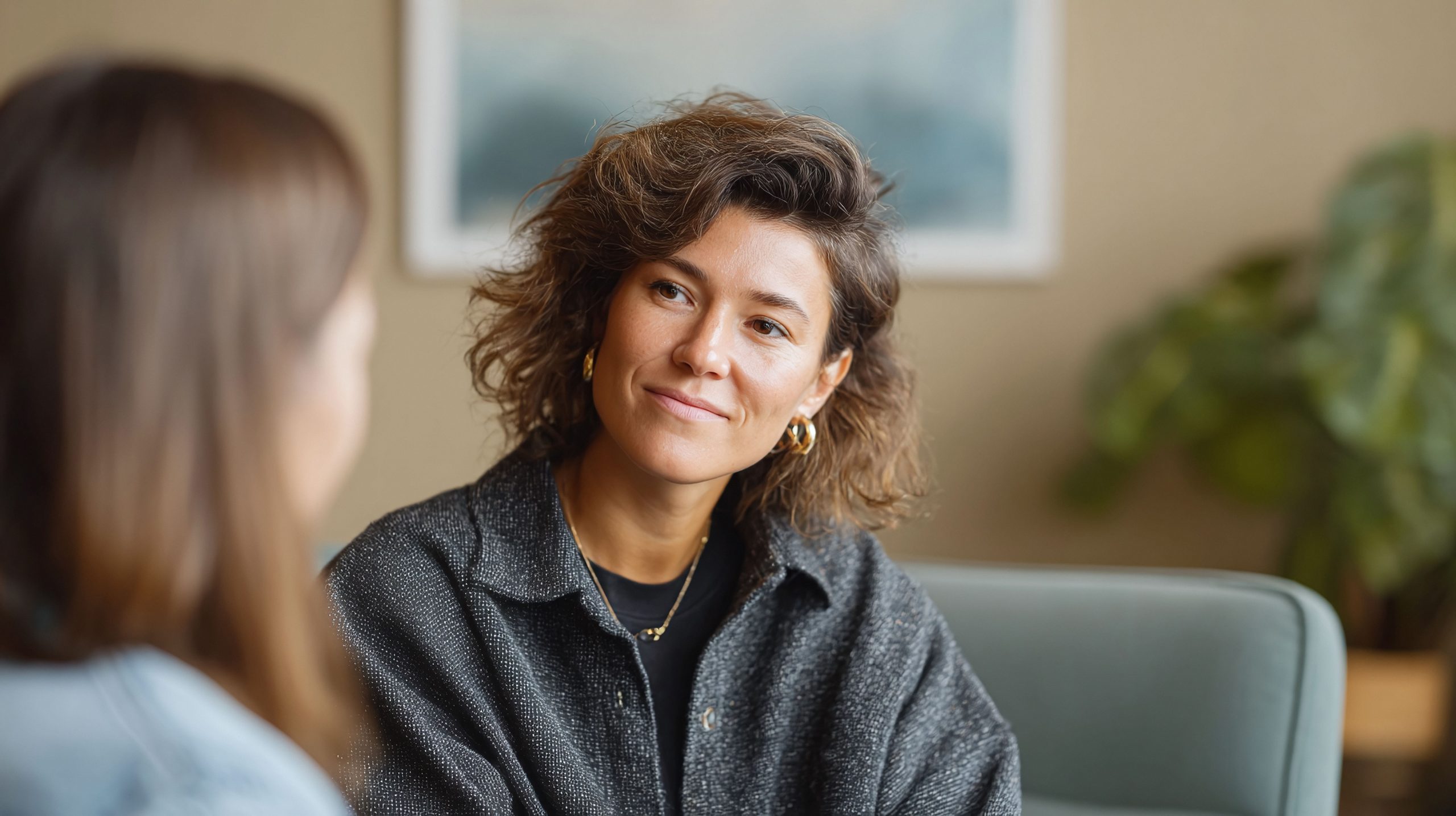 Two accomplished women having a thoughtful coaching conversation