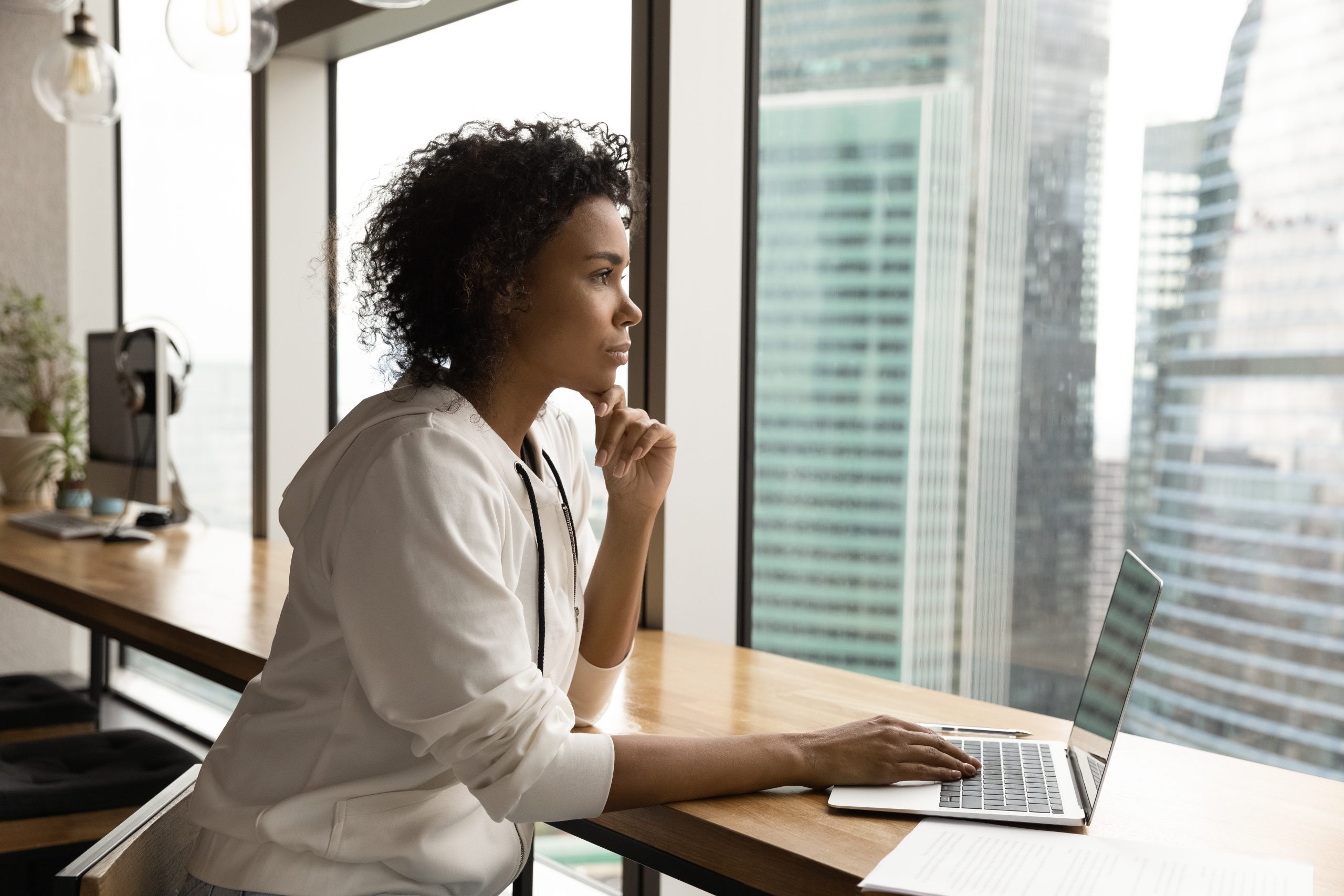 Accomplished woman thoughtfully considering a consequential decision